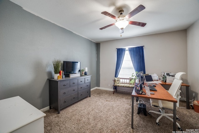 carpeted office space featuring ceiling fan