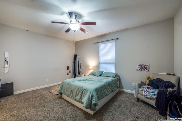 carpeted bedroom with ceiling fan and a textured ceiling