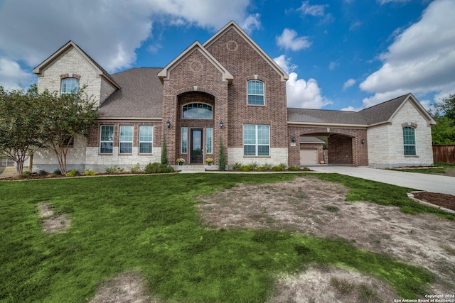 french country style house with a garage and a front lawn