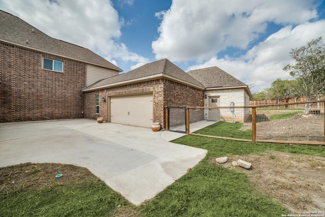 view of home's exterior featuring a garage and a yard