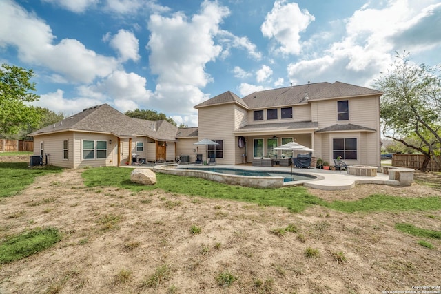 rear view of house with a fenced in pool, a patio, and central AC unit