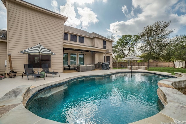 view of pool featuring outdoor lounge area, ceiling fan, and a patio area