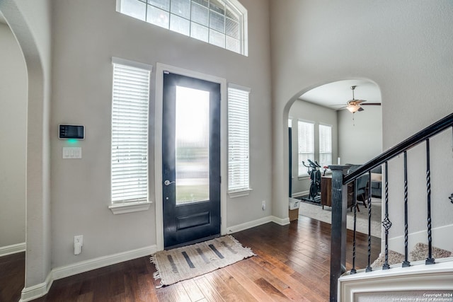 entryway with dark hardwood / wood-style flooring and ceiling fan