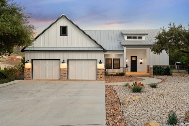 view of front facade with a porch and a garage