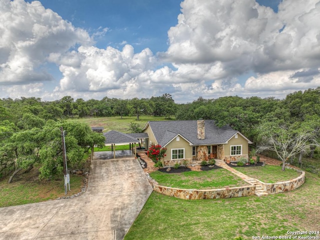 single story home with a front yard and a carport