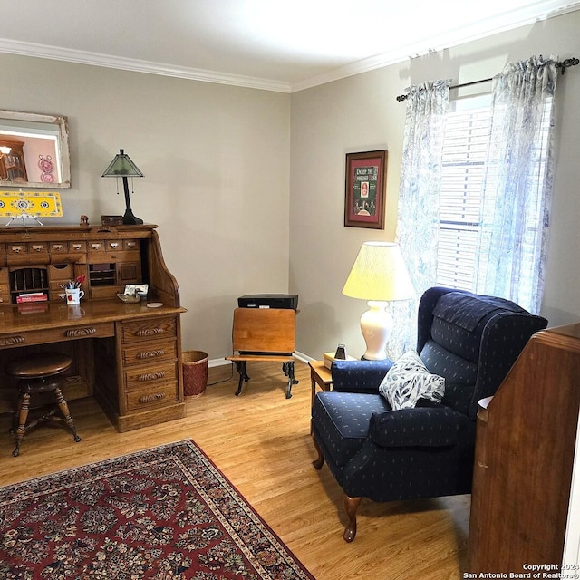 sitting room featuring light hardwood / wood-style floors and crown molding