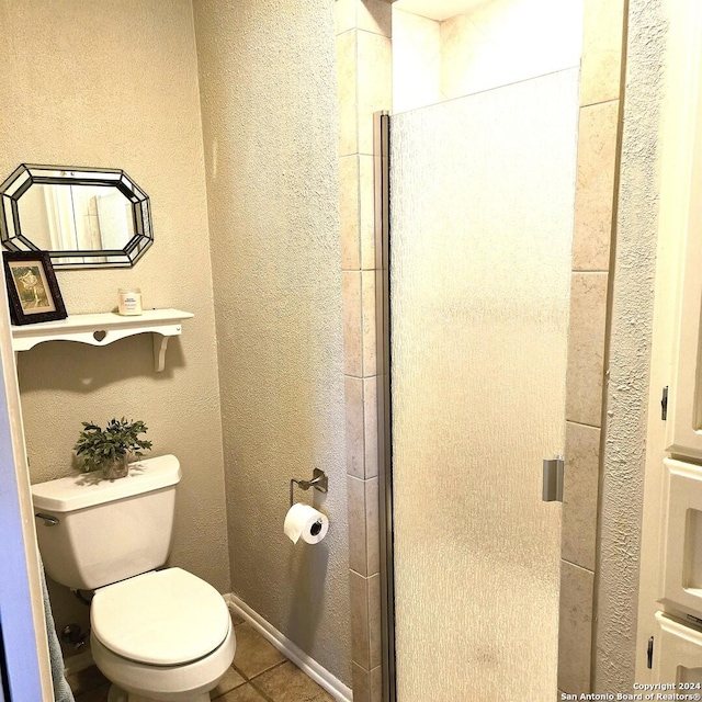 bathroom featuring tile patterned flooring and toilet