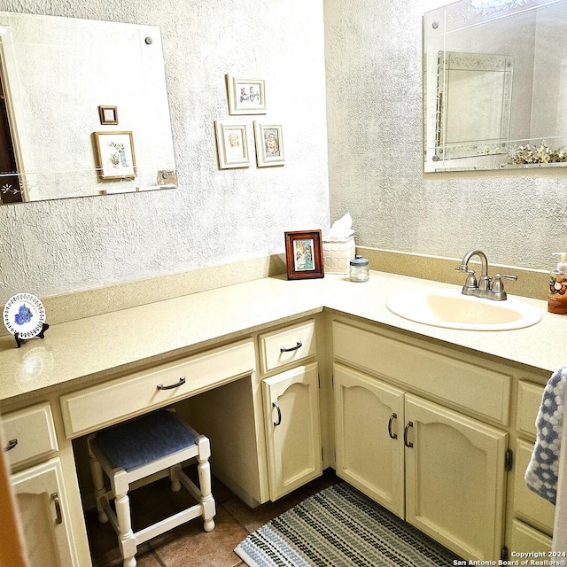 bathroom with tile patterned flooring and vanity