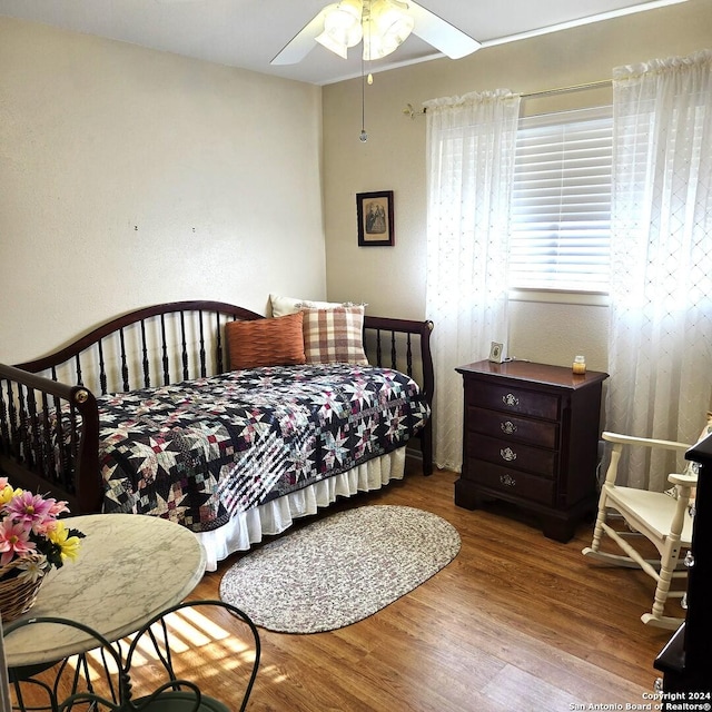 bedroom with light hardwood / wood-style floors and ceiling fan