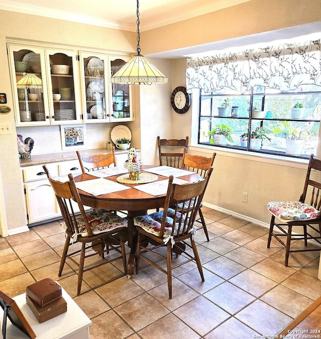 tiled dining area featuring ornamental molding