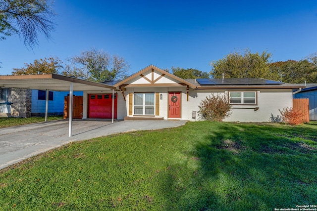 ranch-style house with a front lawn, a garage, and solar panels