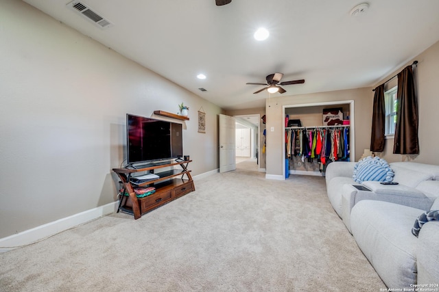 living room with ceiling fan and carpet