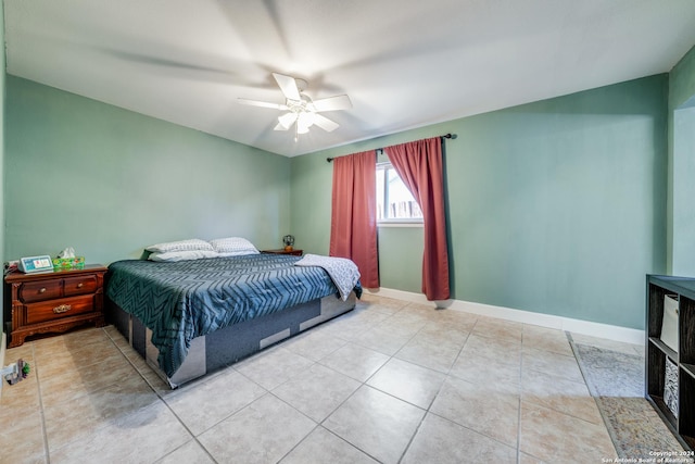 tiled bedroom featuring ceiling fan