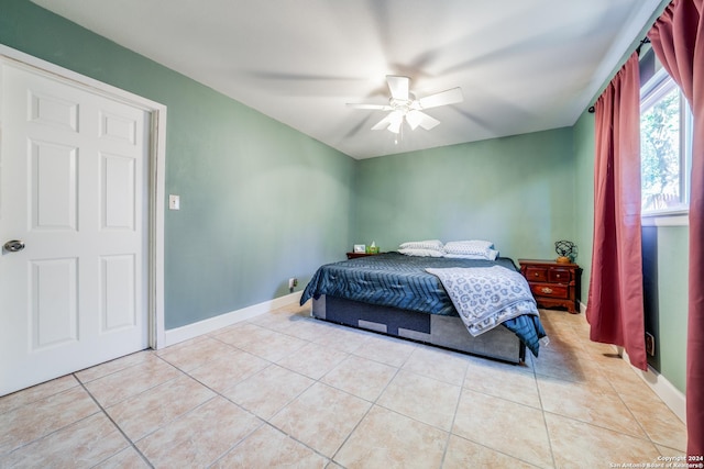 tiled bedroom featuring ceiling fan