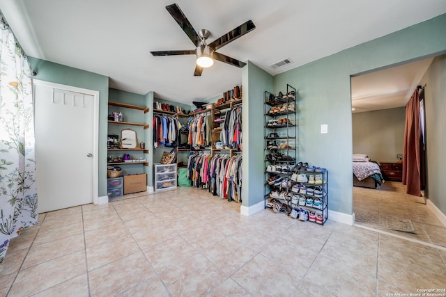 spacious closet with ceiling fan and light tile patterned floors