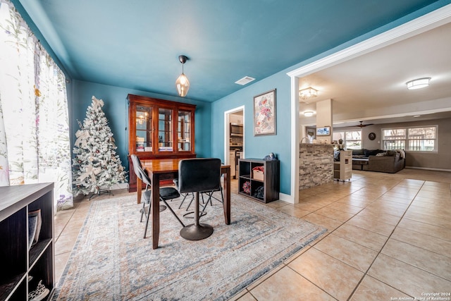 dining area featuring ceiling fan and light tile patterned floors