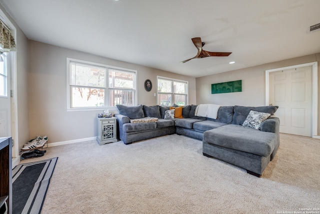 living room with ceiling fan and light colored carpet