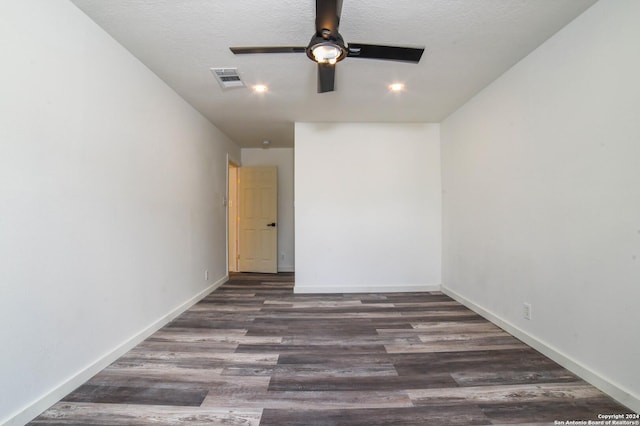 empty room featuring a textured ceiling, dark hardwood / wood-style floors, and ceiling fan