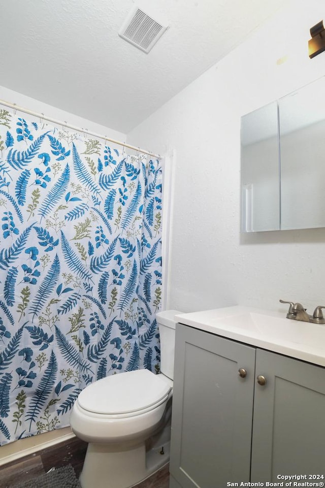 bathroom with a shower with curtain, vanity, toilet, and wood-type flooring