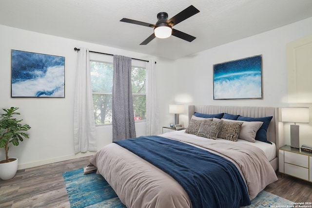 bedroom with hardwood / wood-style floors and ceiling fan