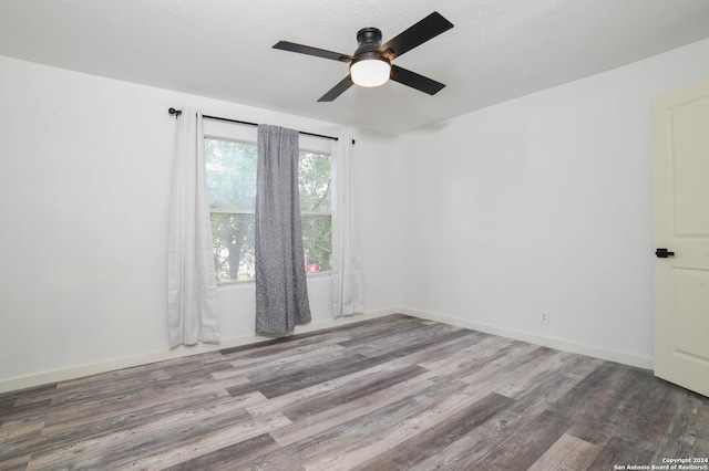 empty room featuring ceiling fan, hardwood / wood-style floors, and a textured ceiling