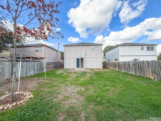 rear view of house with a yard