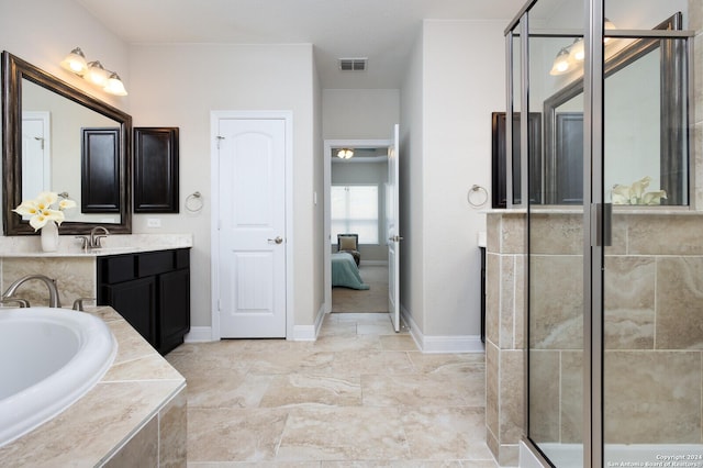 bathroom with vanity and independent shower and bath