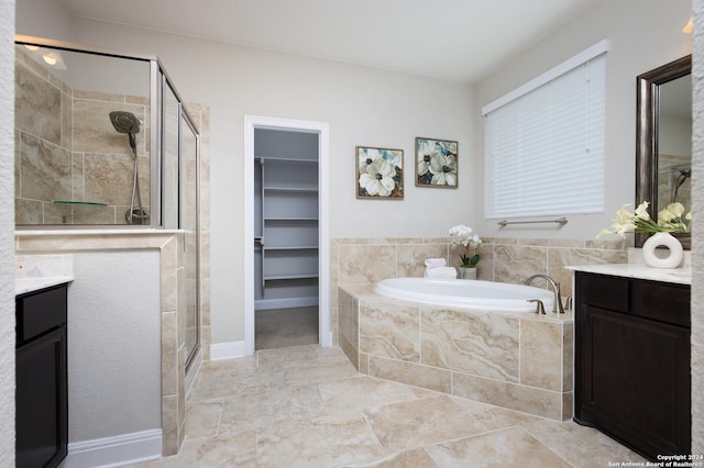 bathroom with shower with separate bathtub and vanity