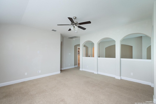 unfurnished room with light carpet and vaulted ceiling