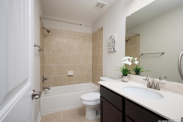 full bathroom with tile patterned floors, a textured ceiling, toilet, vanity, and tiled shower / bath