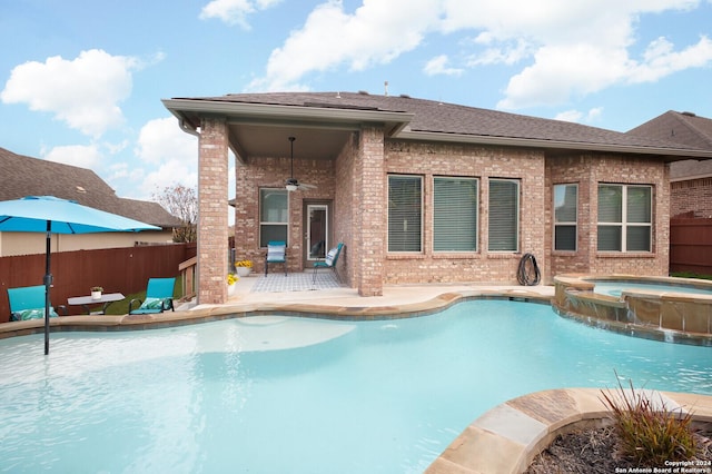 view of pool with ceiling fan, an in ground hot tub, and a patio