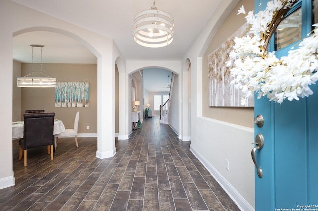 entrance foyer with a chandelier and dark hardwood / wood-style floors