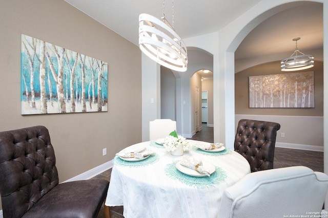 dining area with a chandelier and dark hardwood / wood-style floors