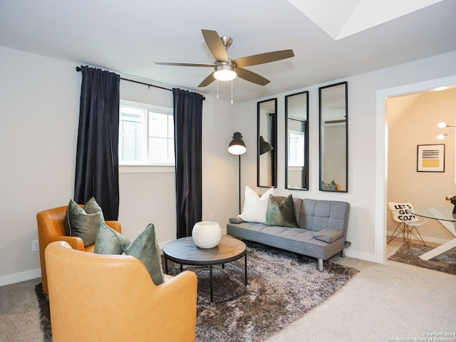 living room with carpet flooring, ceiling fan, and lofted ceiling