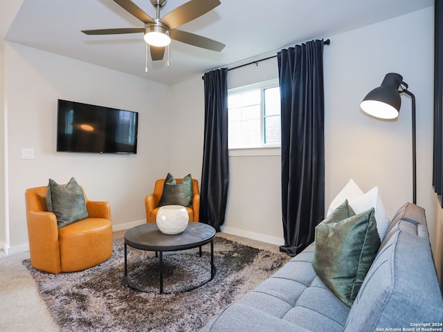 carpeted living room featuring ceiling fan