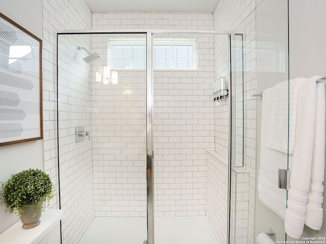 bathroom featuring a shower with door