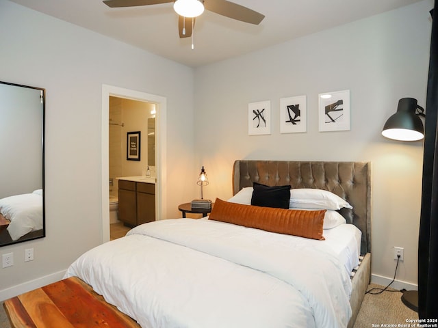 bedroom with ceiling fan, light wood-type flooring, and ensuite bath