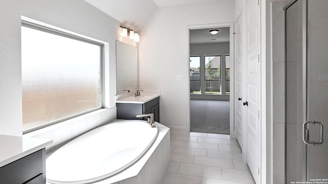 full bath with vanity, tile patterned floors, a bath, and a shower stall