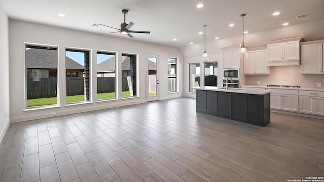kitchen with ceiling fan, visible vents, light countertops, a sink, and stainless steel appliances