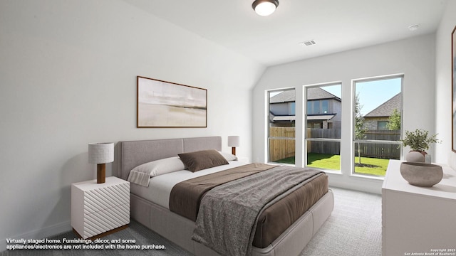 carpeted bedroom featuring baseboards and visible vents
