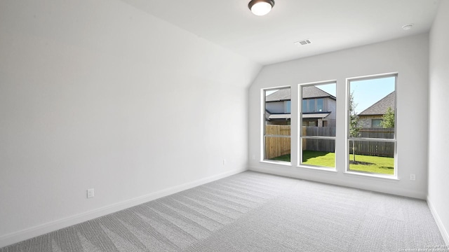 carpeted spare room with baseboards and visible vents