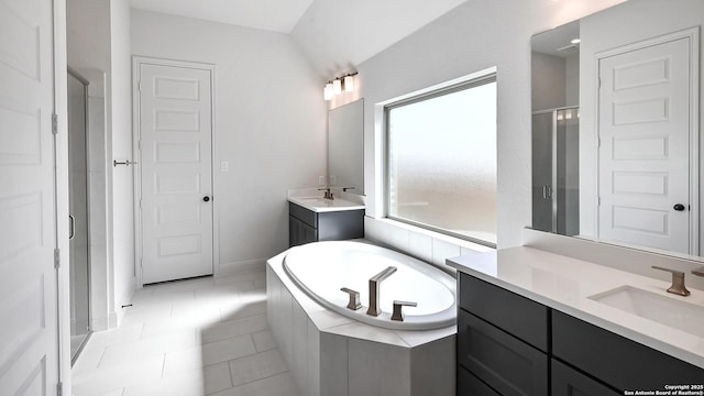 full bathroom featuring a garden tub, tile patterned flooring, two vanities, a sink, and a stall shower