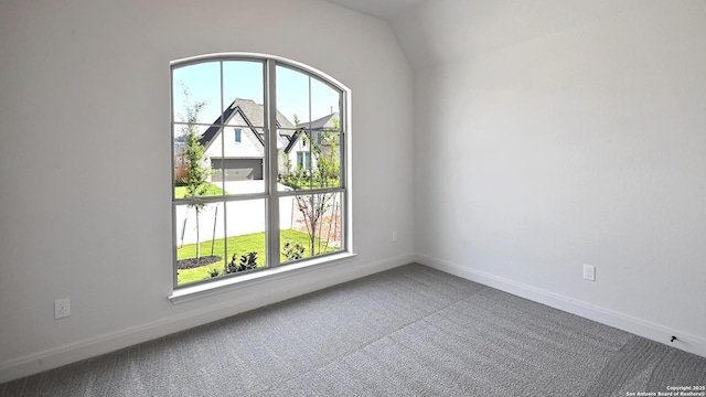 empty room with baseboards and carpet
