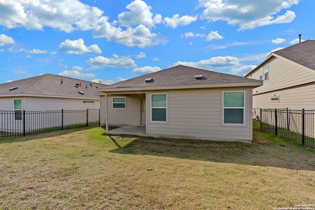 rear view of house with a lawn and a patio area