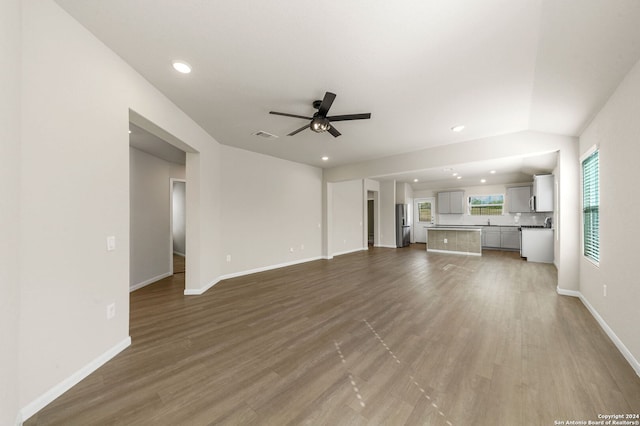 unfurnished living room with hardwood / wood-style flooring and ceiling fan