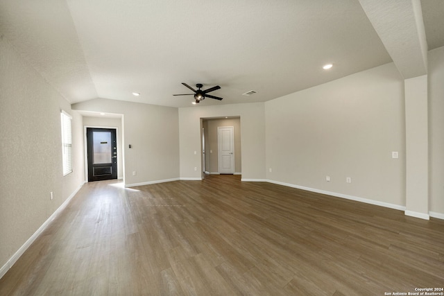 unfurnished living room with ceiling fan, hardwood / wood-style floors, and lofted ceiling