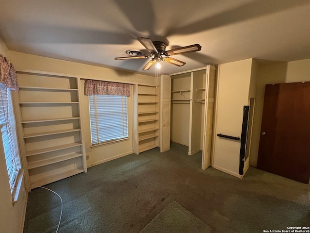 unfurnished bedroom with a closet, dark carpet, and ceiling fan