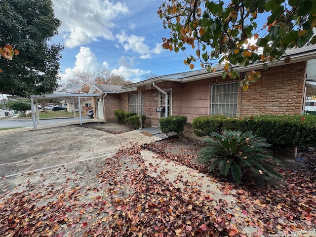 single story home featuring a carport