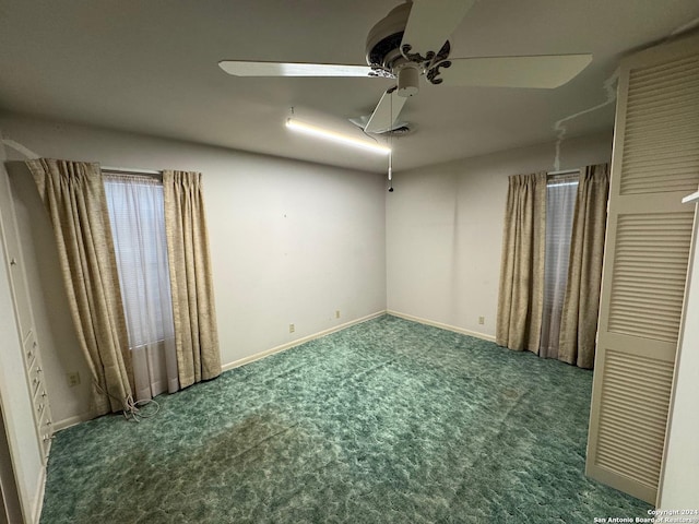 unfurnished room with ceiling fan and carpet floors