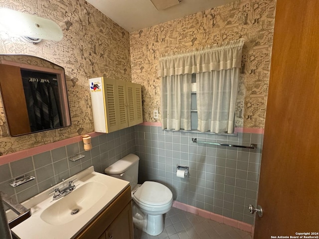 bathroom with tile patterned floors, vanity, and tile walls